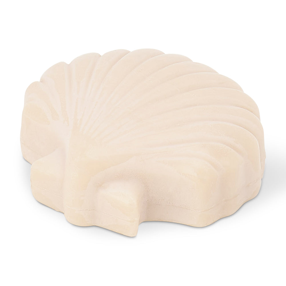 Beige shell-shaped soap on a white background