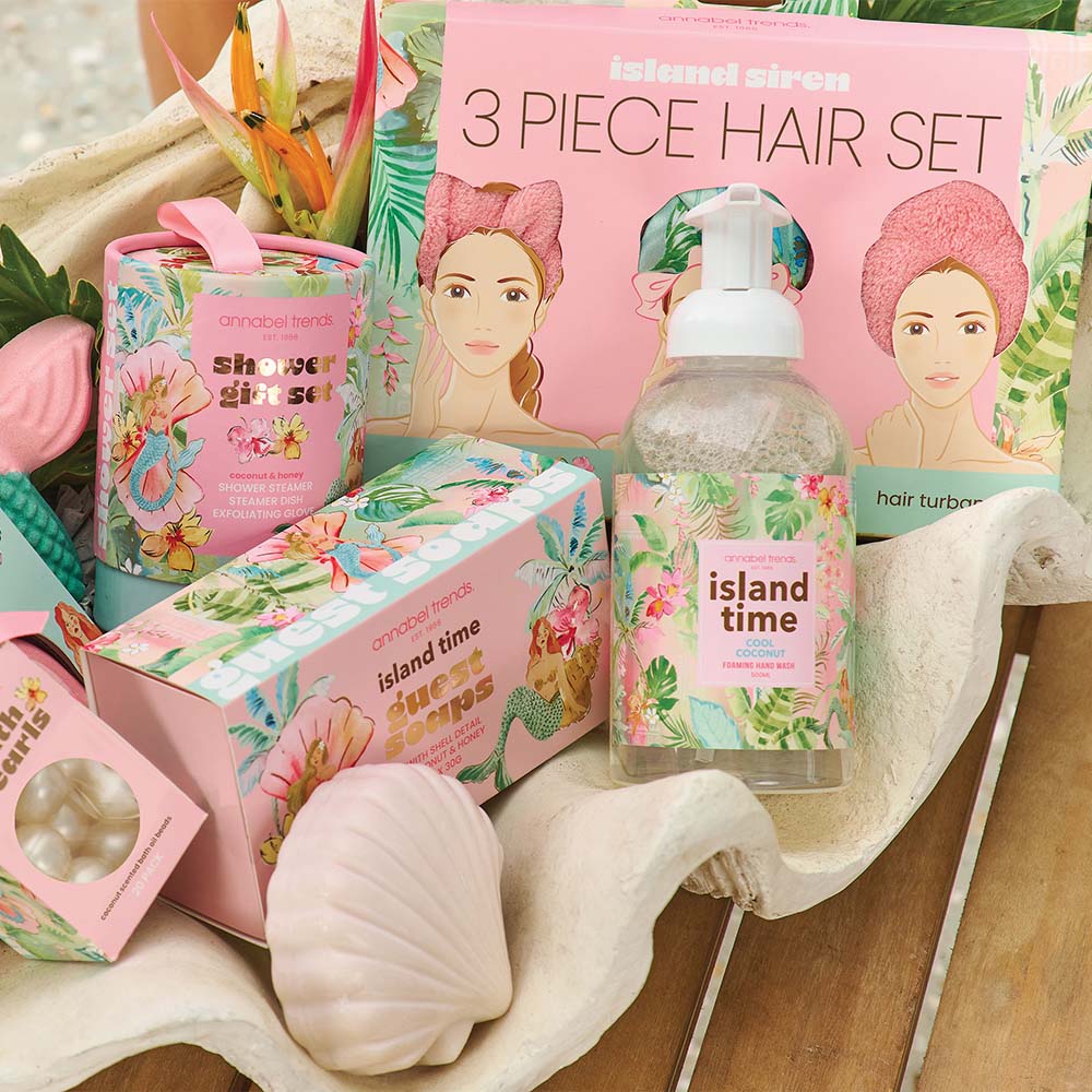 Island Time hair care products including a bottle, boxes, and a towel on a wooden surface.