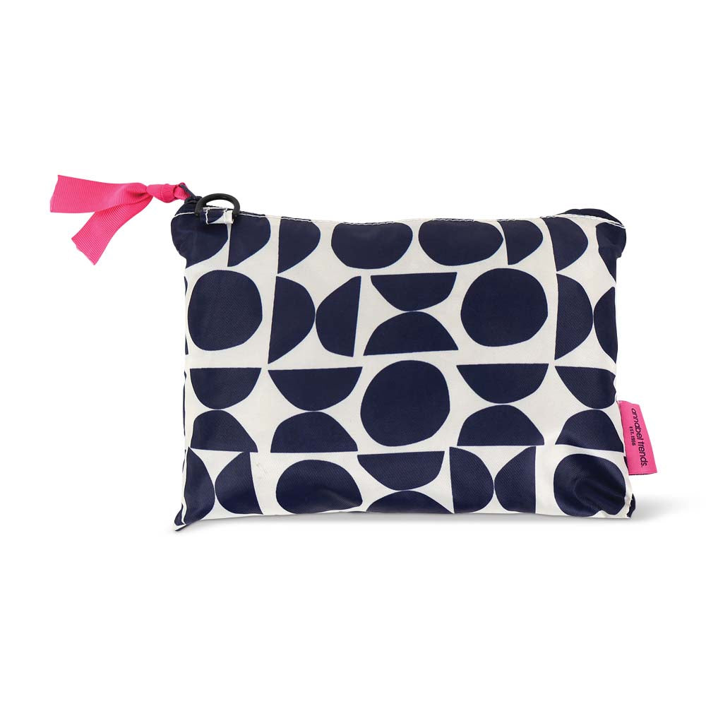 Navy and white patterned travel packing cube case with pink accents on a white background