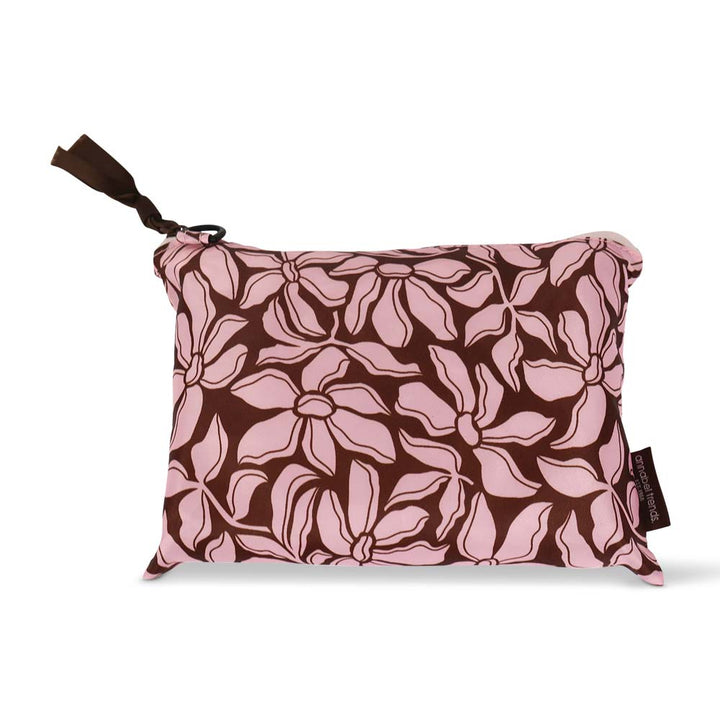 Floral-patterned travel packing cube case with a brown strap on a white background