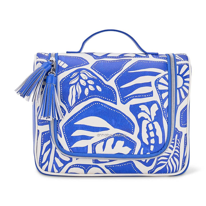 Blue and white patterned bag with tassel on a white background