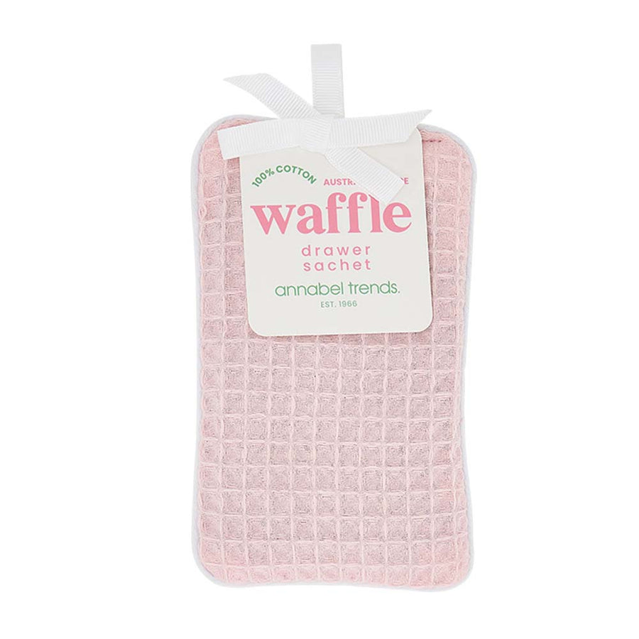 Pink waffle-textured drawer sachet with a label on a white background