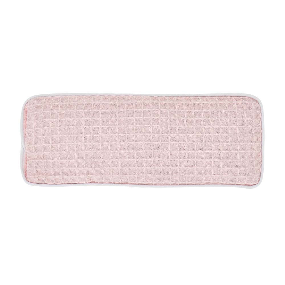 Pink textured rectangular cushion on a white background