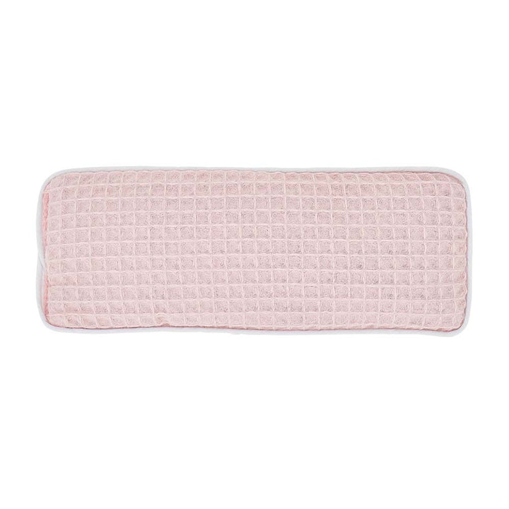 Pink textured rectangular cushion on a white background