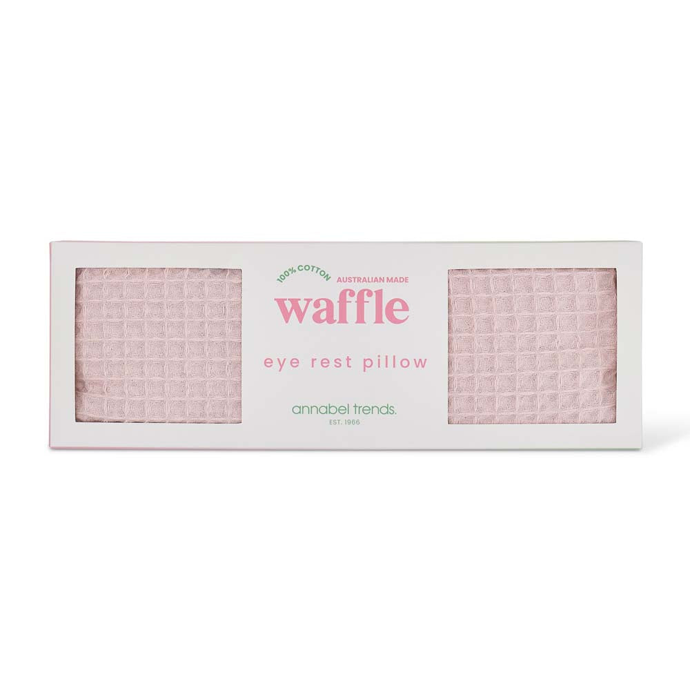 Waffle eye rest pillow packaging with pink waffle pattern on a white background