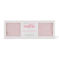 Waffle eye rest pillow packaging with pink waffle pattern on a white background