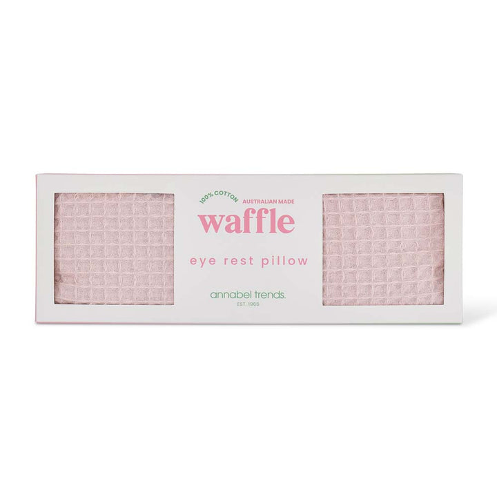 Waffle eye rest pillow packaging with pink waffle pattern on a white background