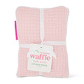 Pink waffle heat pack with a visible brand tag on a white background