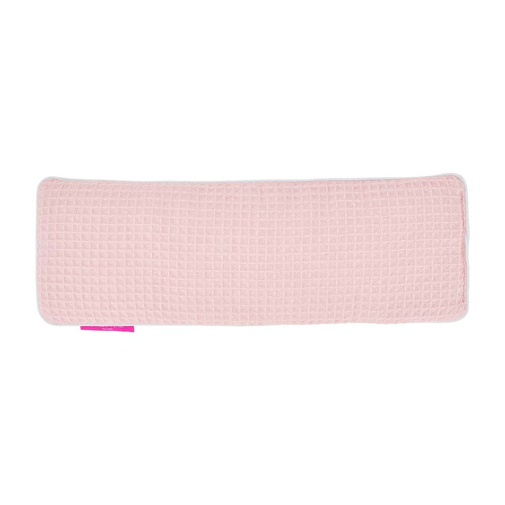 Pink textured heat pack on a white background