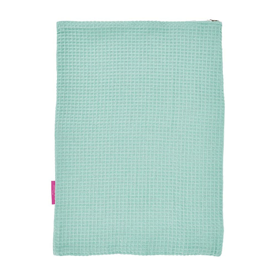 Light blue textured towel with a pink tag on a white background