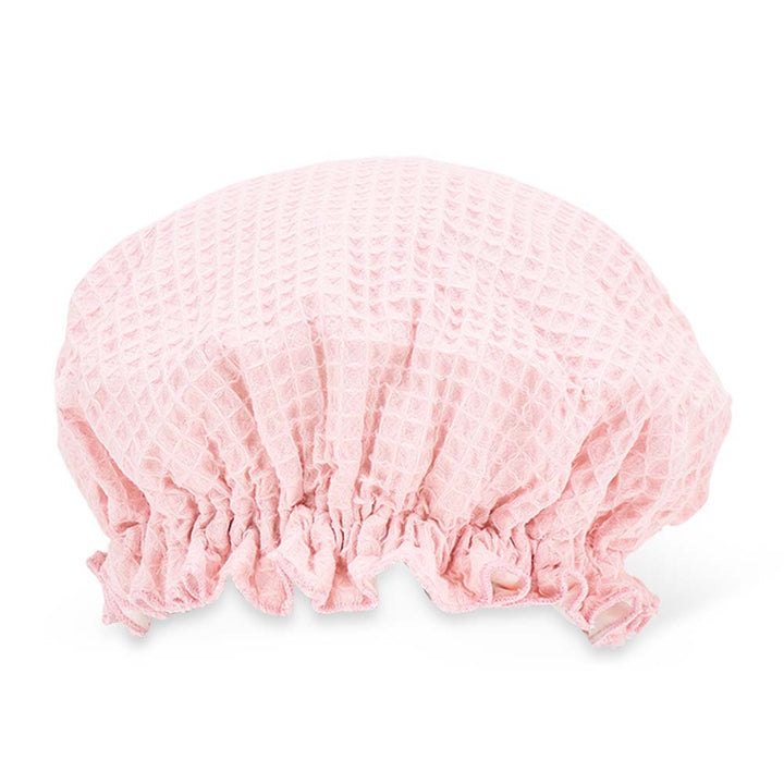 Pink shower cap on a white background