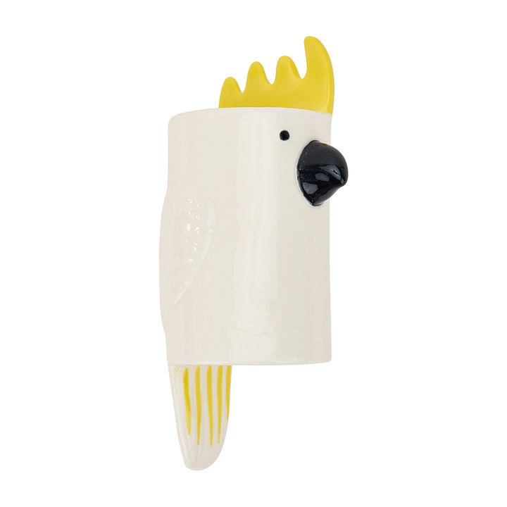 White ceramic wall vase shaped like a cockatoo with yellow crest and beak on a white background