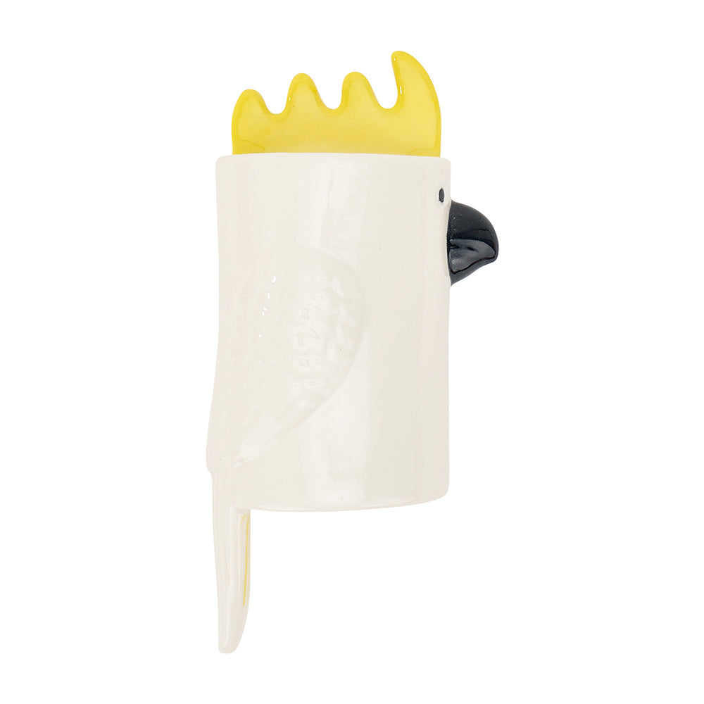 White ceramic wall vase shaped like a cockatoo with yellow crest and beak on a white background