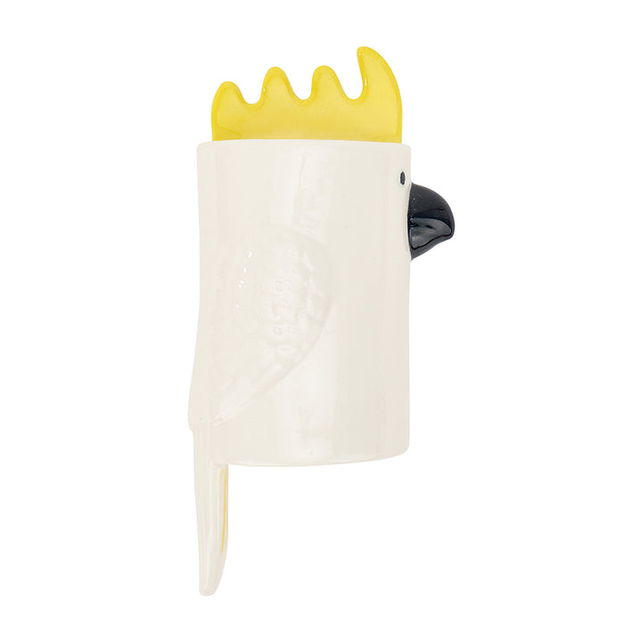 White ceramic wall vase shaped like a cockatoo with yellow crest and beak on a white background