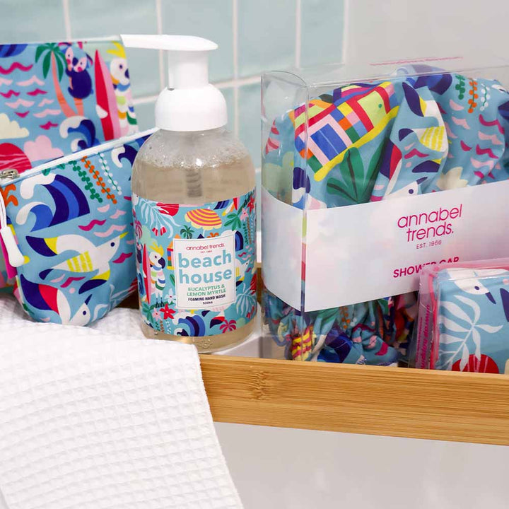 Bathroom scene with colorful bath products including a bottle and packaging from Annabel Trends.