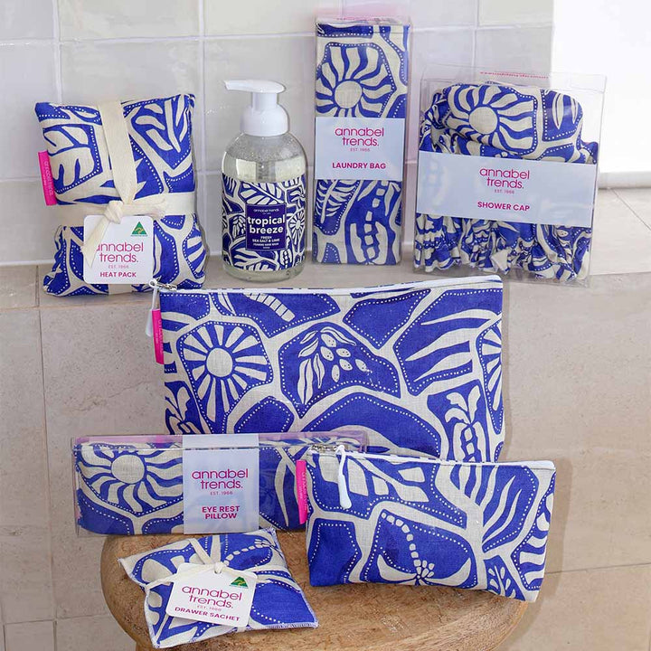 Set of Annabel Trends bathroom products with blue and white patterns on a tiled floor.
