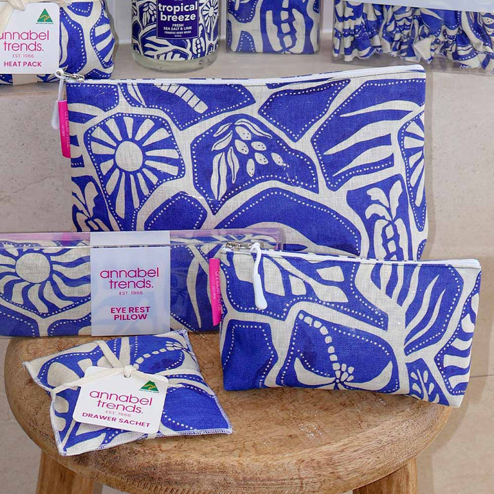Blue and white patterned pouches with 'annabel trends' packaging on a wooden stool.