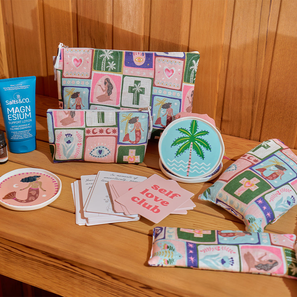 Collection of colorful pouches, coasters, and cards on a wooden surface