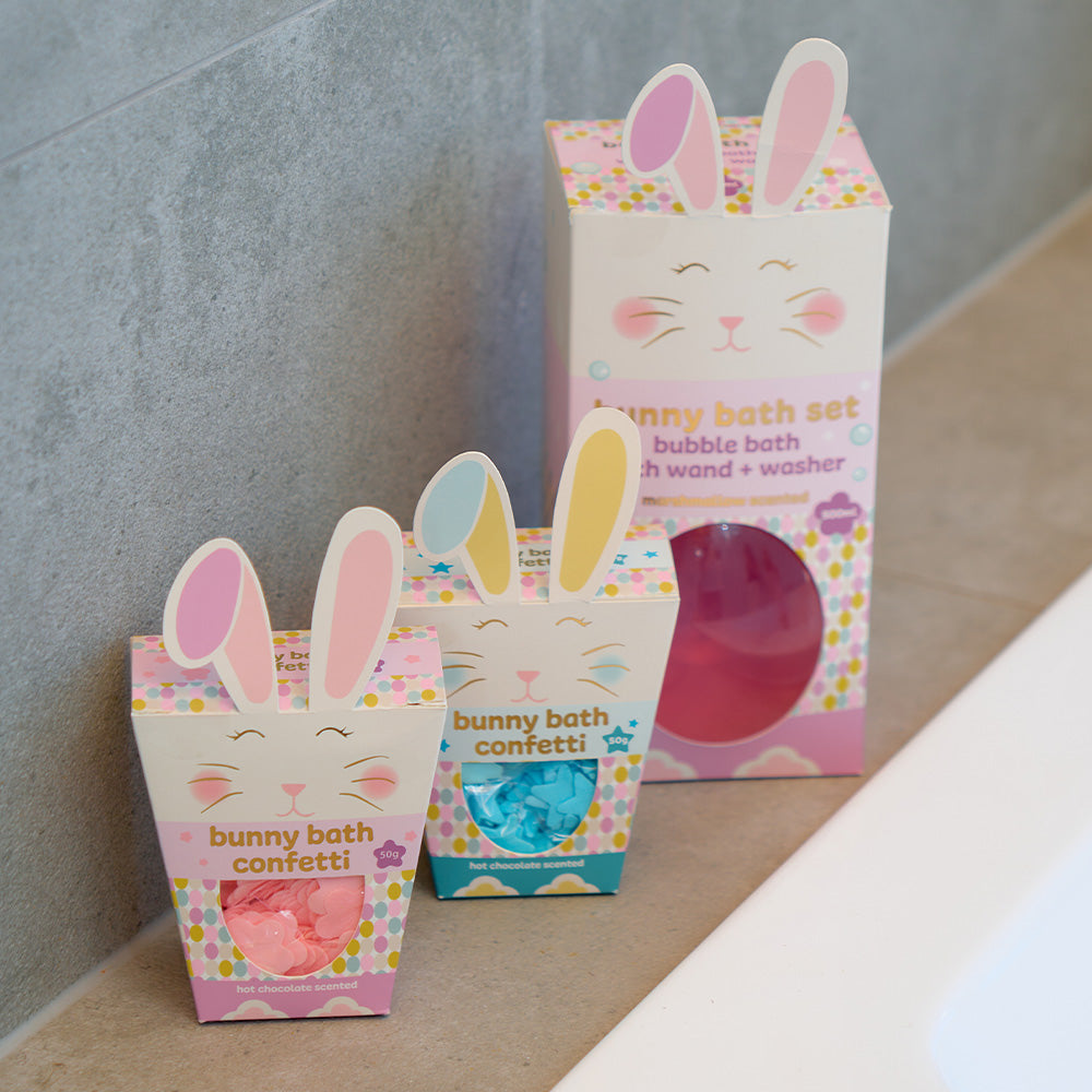 Three bunny-themed bath products in colorful packaging on a neutral background