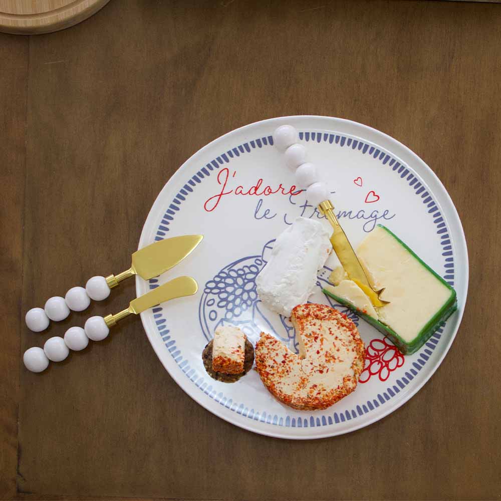 Plate with cheese and crackers on a wooden surface