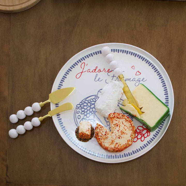 Plate with cheese and crackers on a wooden surface