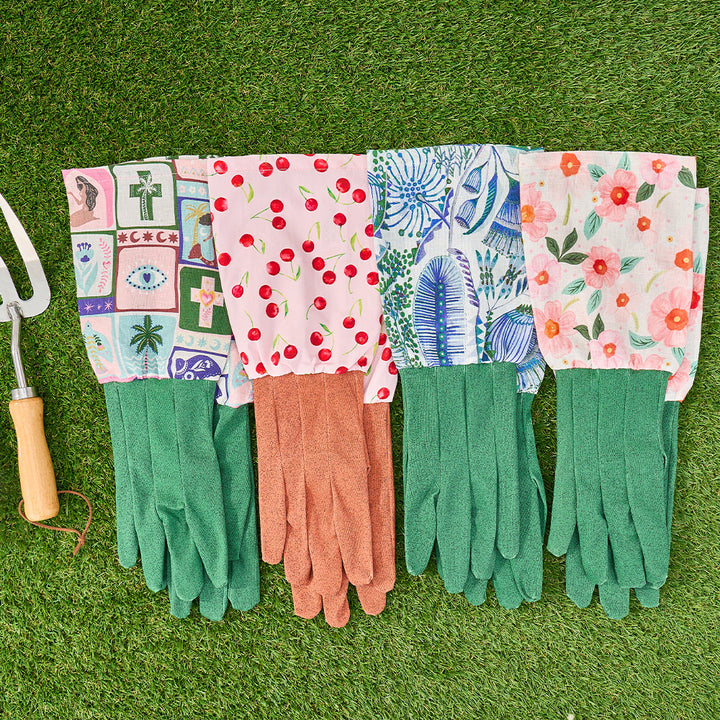 Colorful gardening gloves with patterned cuffs on a grass background