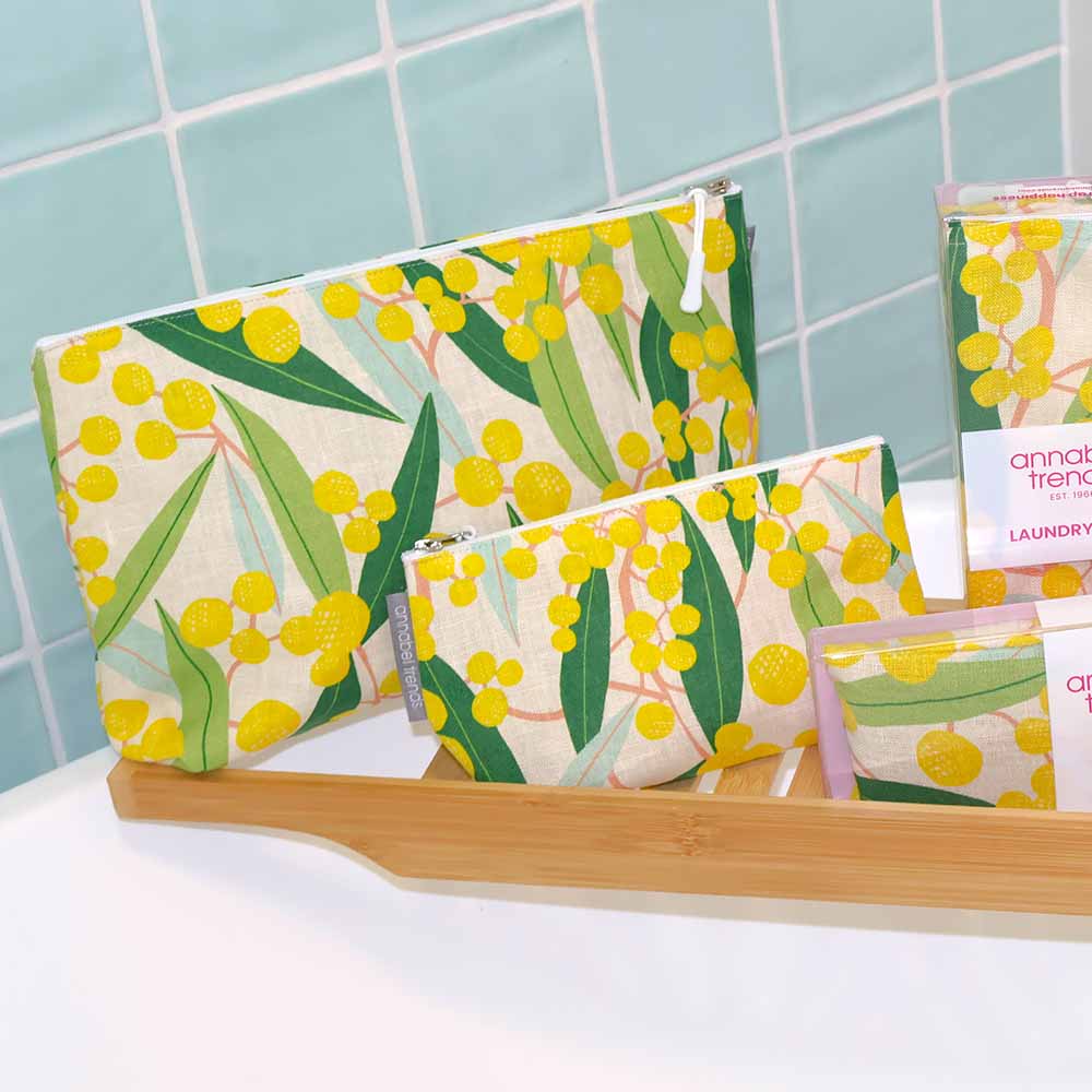 Set of floral-patterned bags on a white surface with a tiled wall background