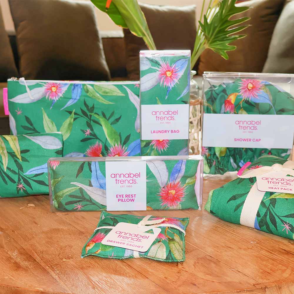 Collection of green floral products from Annabel Trends on a wooden surface.