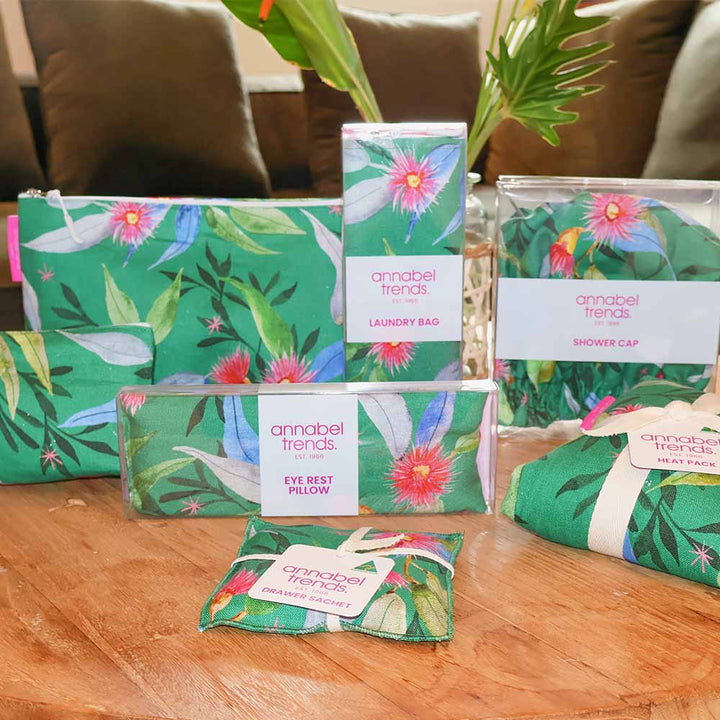 Collection of green floral products from Annabel Trends on a wooden surface.