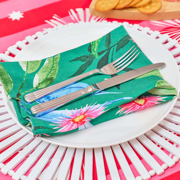 gumnut themed napkin with cutlery on a white plate against a colorful background