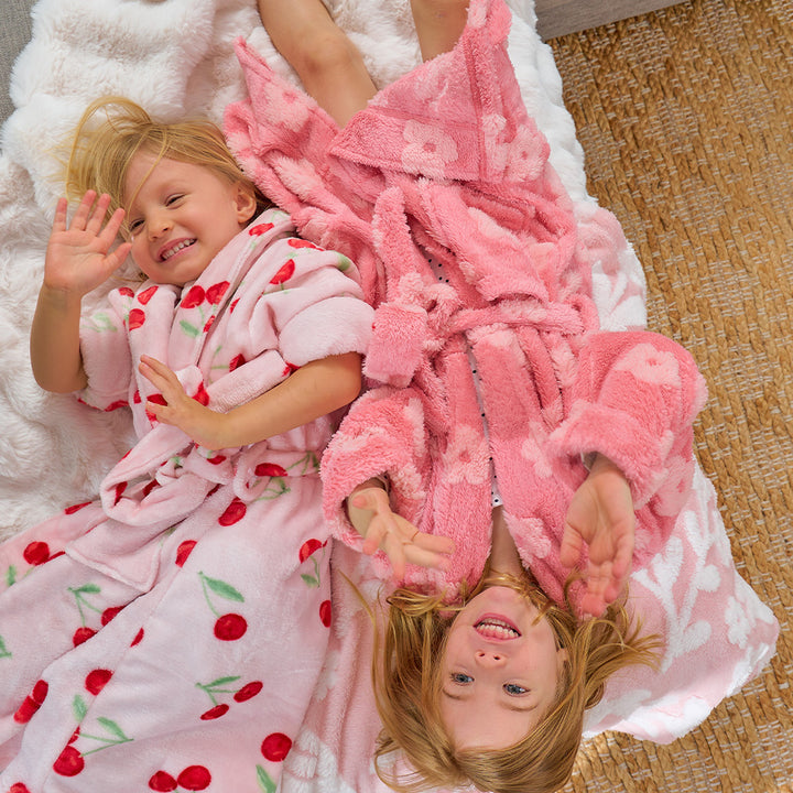 Two children in pink robes with cherry pattern and embossed flower pattern