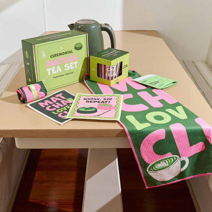 Ceremonial Matcha Tea Set with packaging, teapot, and tea bags on a wooden table.