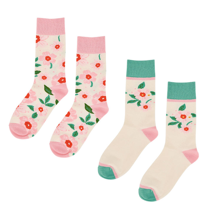 Two pairs of socks with floral patterns on a white background