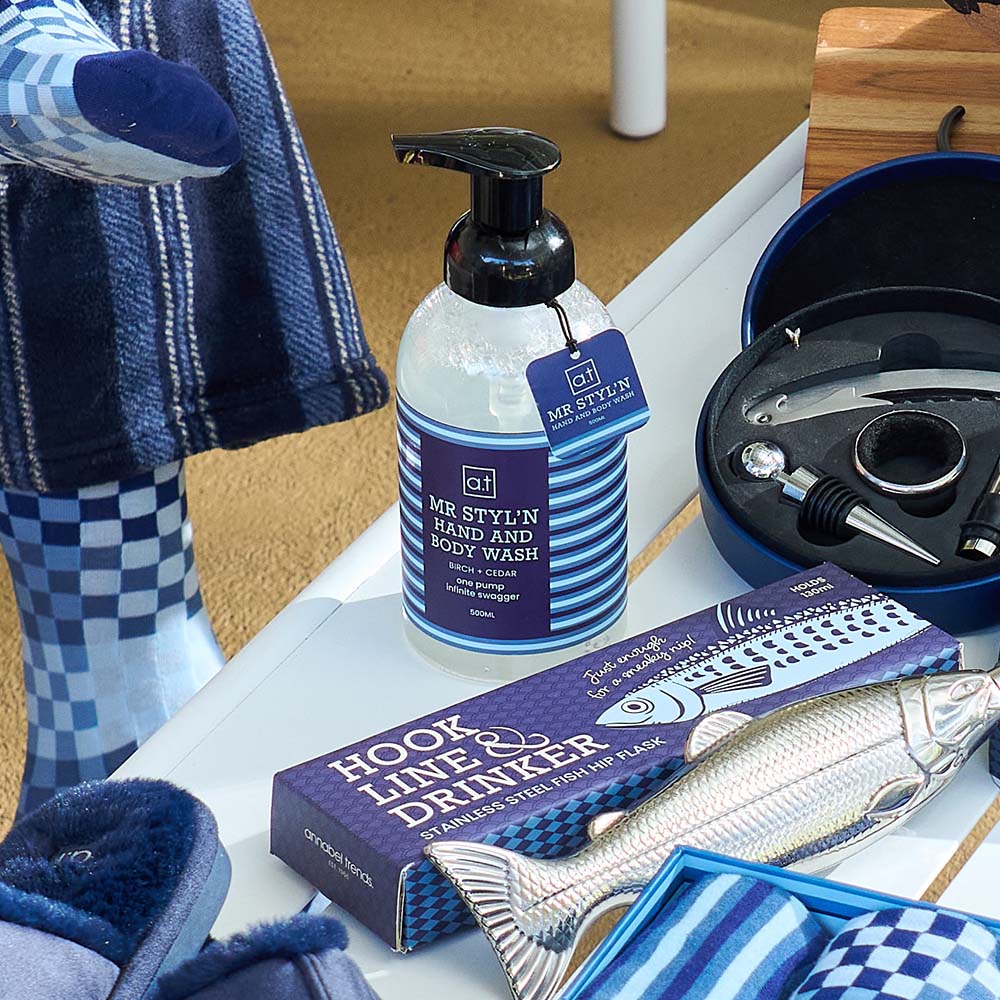 Hand and body wash bottle with a fishing-themed box on a table