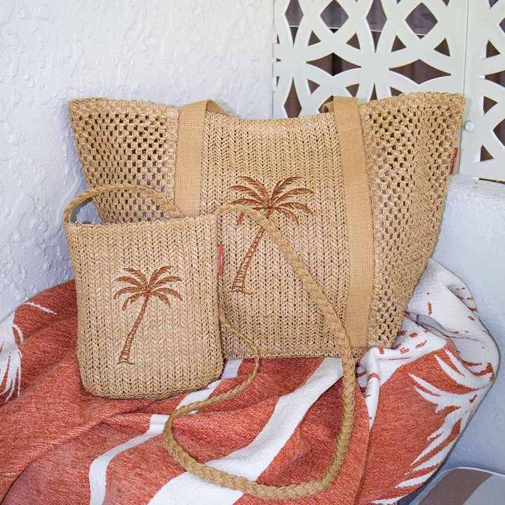 Woven bag with palm tree design on a towel