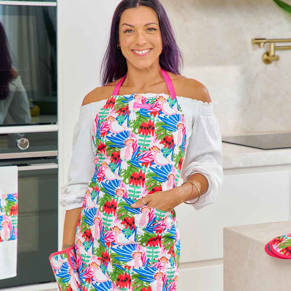 Woman wearing a colorful apron in a kitchen