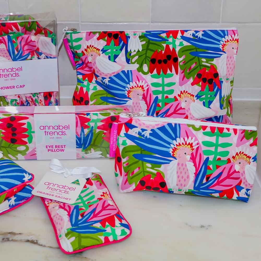 Colorful cosmetic pouches with tropical patterns and 'annabel Trends' branding on a marble surface.