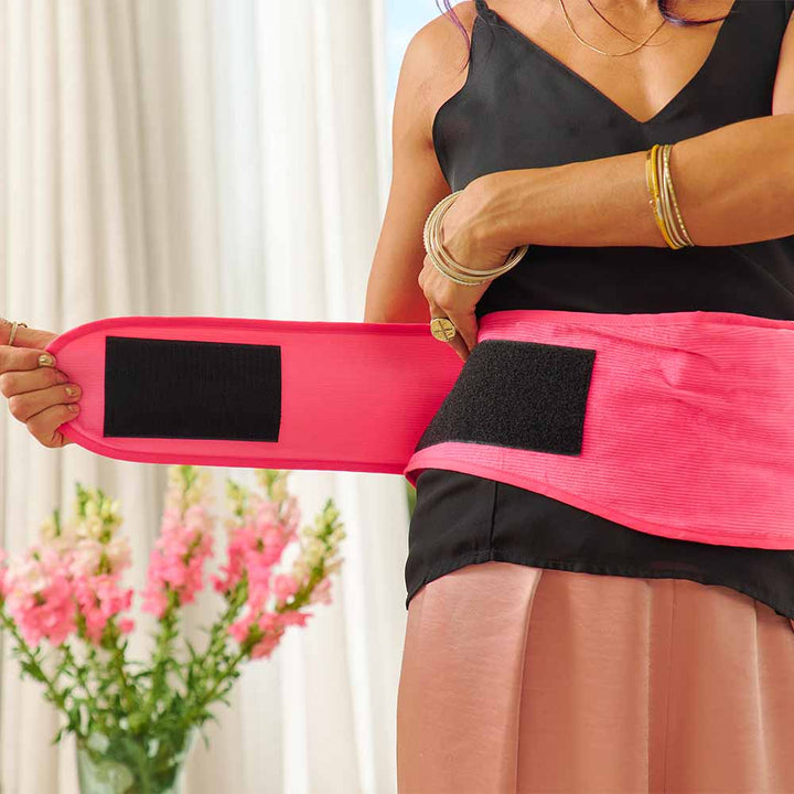 Person wearing a pink heat wrap with a blurred background
