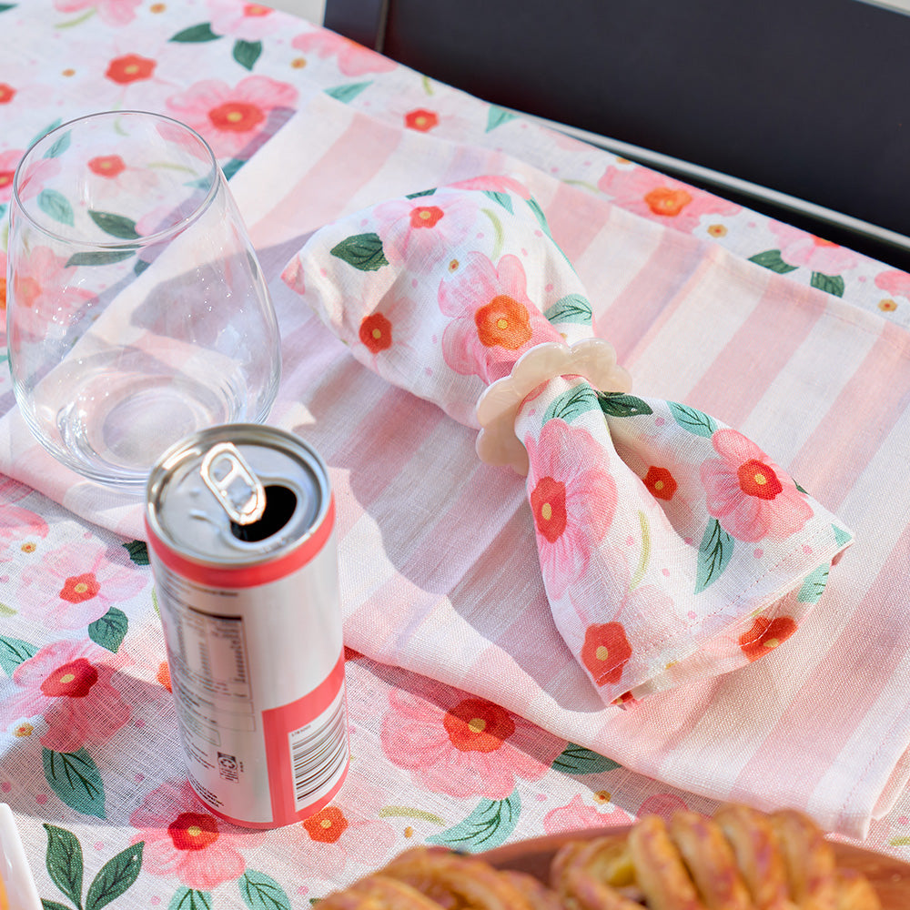 Floral-patterned fabric with a can of pop and cookies on a matching tablecloth.