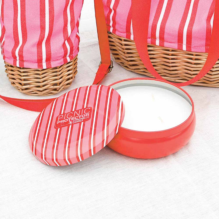 Pink striped picnic protector with a wicker basket on a white background