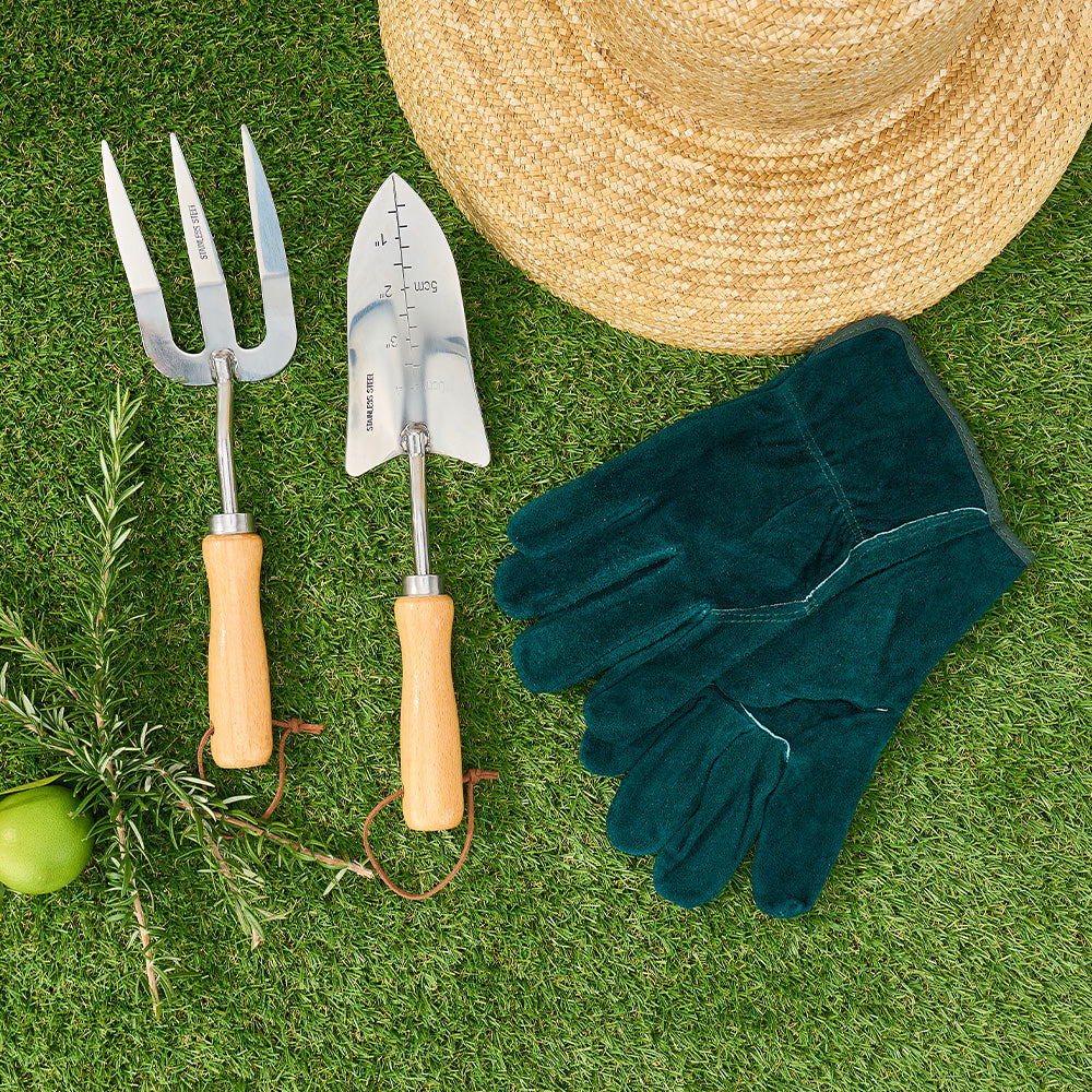 green sprout leather gloves and sprout tool set on grass