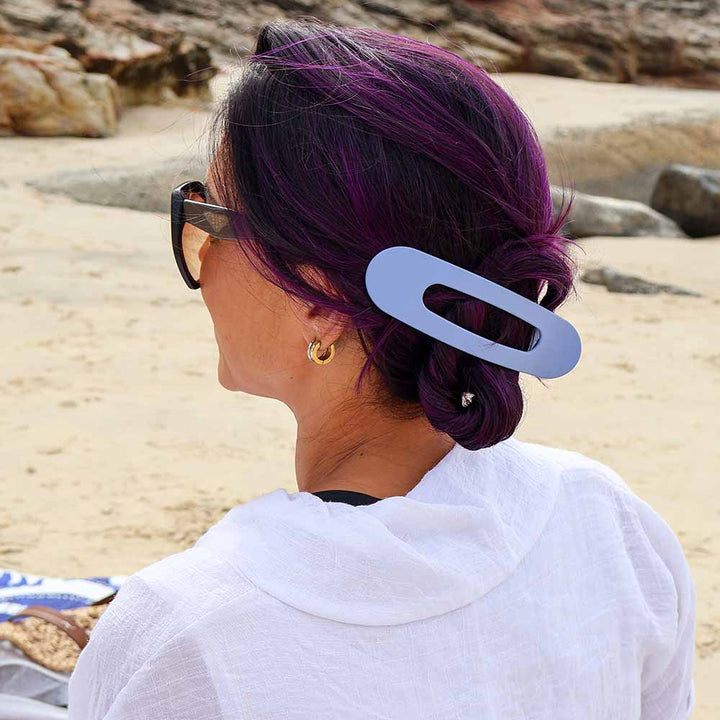 women wearing a blue long flat hair lip in her hair