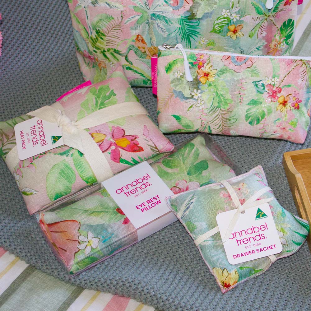 Floral patterned bags and pouches with 'annabel trends' labels on a textured surface.