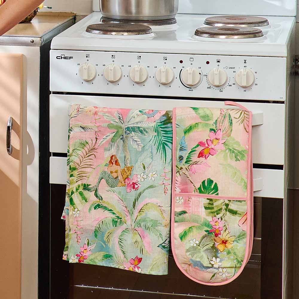 Floral oven mitt and pot holder on a white stove
