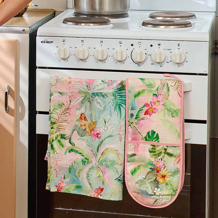 Floral oven mitt and pot holder on a white stove