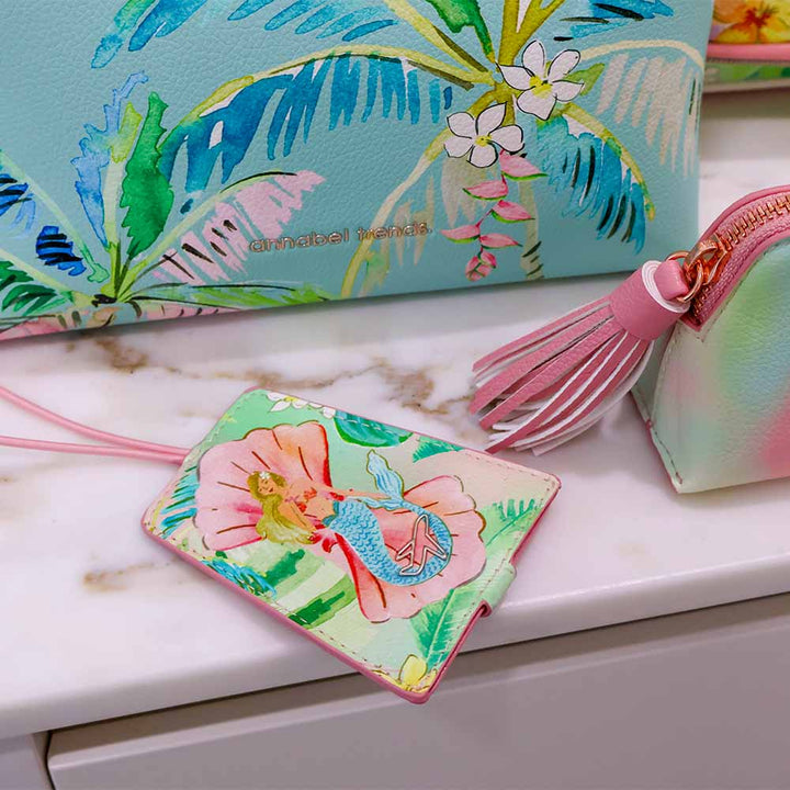 Colorful pouches with floral designs on a marble surface