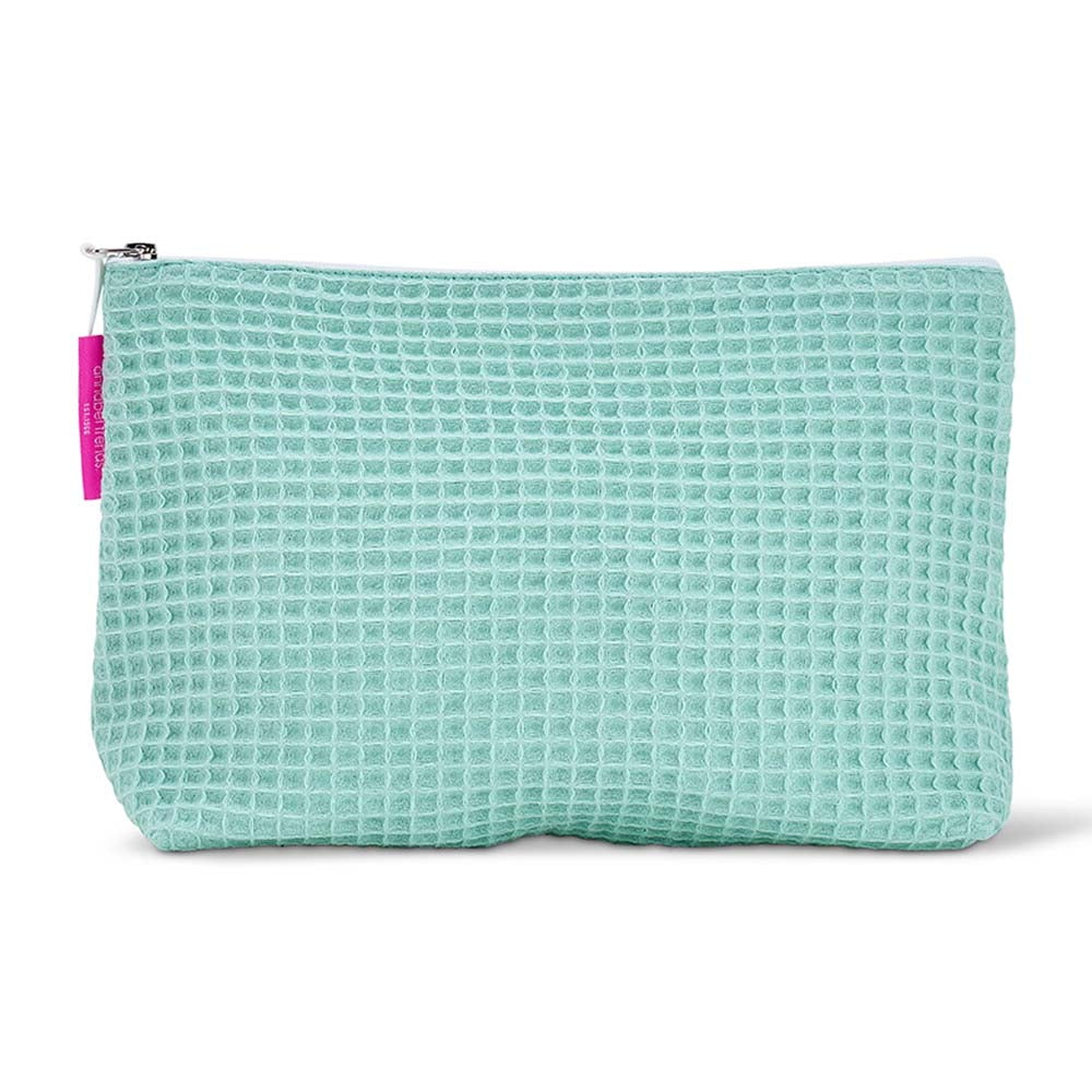 Light blue waffle-textured cosmetic bag with a white zipper on a white background