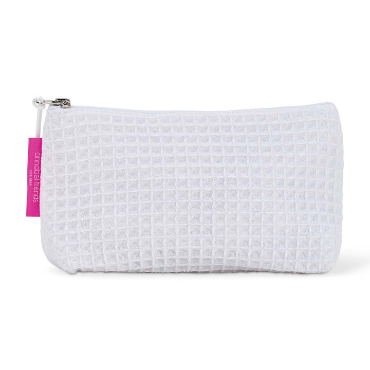 White waffle-textured cosmetic bag with a pink tag on a white background