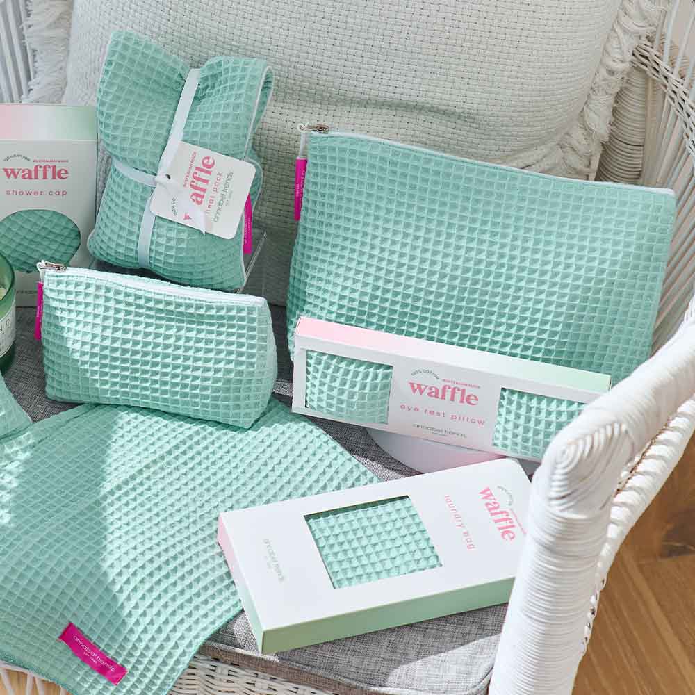 Mint green waffle-textured products on a white chair
