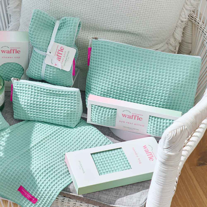 Mint green waffle-textured products on a white chair